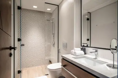 a bathroom with a toilet and a sink and a shower at Creek Escape - Palace Residences - Creek Harbour in Dubai