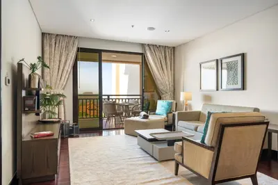a living room with a couch and a table at Palm Retreat - Anantara North - Palm Jumeirah in Dubai