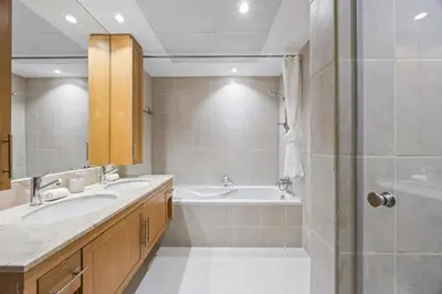 a bathroom with a tub and a sink and a shower at SanctuaryStays - A Luxury apartment with Full Burj Khalifa and Dubai Fountain Views - Dubai Mall Access in Dubai