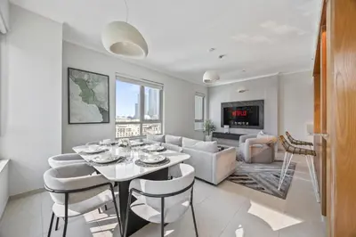 a living room with a table and a couch at SanctuaryStays - A Luxury apartment with Full Burj Khalifa and Dubai Fountain Views - Dubai Mall Access in Dubai