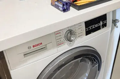 a washing machine with a counter on top of it at High Floor Balcony Suite 8 mins to Burj Khalifa in Dubai