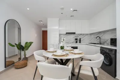 a kitchen with a table and chairs in a kitchen at Gala Guests - Marina Views Bright Balcony Collection in Dubai
