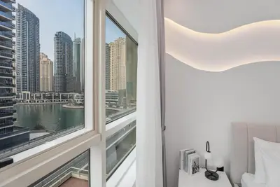 a bedroom with a window with a view of the city at Gala Guests - Marina Views Bright Balcony Collection in Dubai