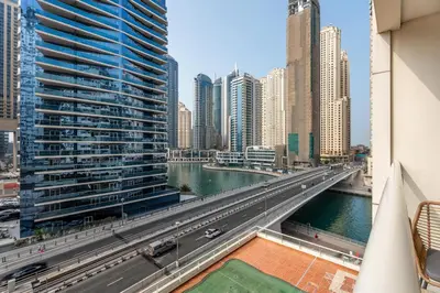 a bridge over a river in a city with tall buildings at Gala Guests - Marina Views Bright Balcony Collection in Dubai