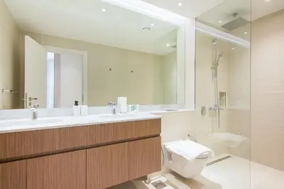 a bathroom with a toilet and a sink and a shower at Cozy 3BR Sea-View Apartment in La Rive 1 in Dubai