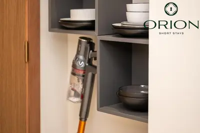 a cabinet with plates and bowls and a knife at Luxury 2BR with Private Jacuzzi Burj & Canal Views MINUTES FROM DUBAI MALL AND BURJ KHALIFA in Dubai