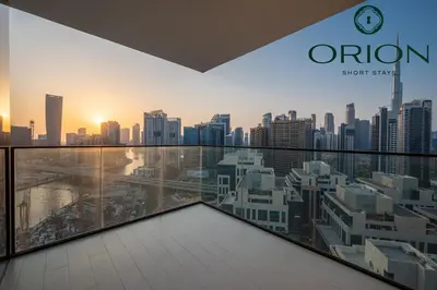 a view of a city skyline from an apartment balcony at Luxury 2BR with Private Jacuzzi Burj & Canal Views MINUTES FROM DUBAI MALL AND BURJ KHALIFA in Dubai
