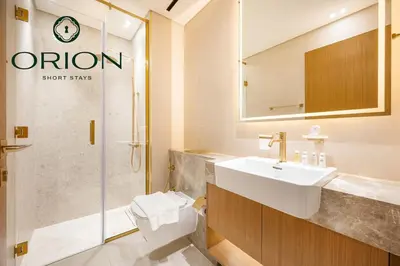 a bathroom with a sink and a toilet and a shower at Luxury 2BR with Private Jacuzzi Burj & Canal Views MINUTES FROM DUBAI MALL AND BURJ KHALIFA in Dubai