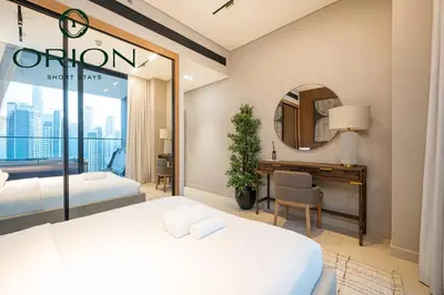 a hotel room with two beds and a mirror at Luxury 2BR with Private Jacuzzi Burj & Canal Views MINUTES FROM DUBAI MALL AND BURJ KHALIFA in Dubai