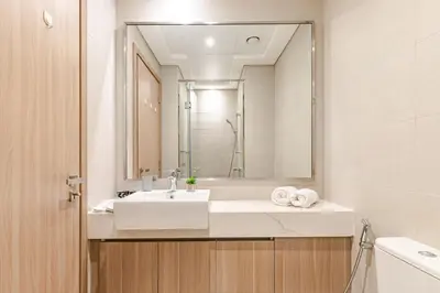 a bathroom with a white sink and a mirror at Greige & Spacious Studio in Dubai
