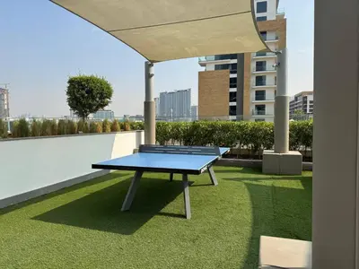 a ping pong table on the roof of a building at Greige & Spacious Studio in Dubai
