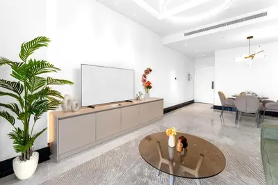 a living room with a tv and a table at Luxury 1BR Terraces Private Jacuzzi Business Bay in Dubai