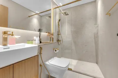a bathroom with a shower and a toilet and a sink at Waves - Comfy and Stylish 1BR with Huge Balcony in Dubai