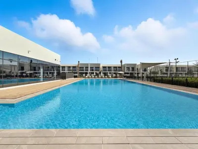 a large swimming pool in front of a building at Golden Stays - Chic 4BR Retreat I Luxe Touches & Serene Views in Dubai
