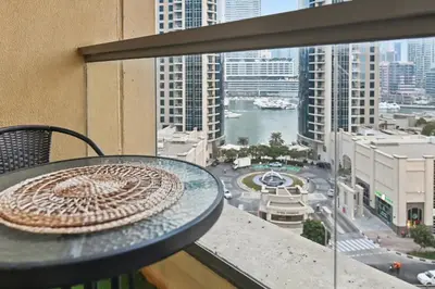 a table on a balcony with a view of a city at Stylish 3BR JBR l Steps to Beach l Balcony l Sleeps 6 in Dubai