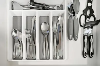 a white container filled with forks and spoons and utensils at Golden Stays - Modern Luxe 4BR Oasis I Peaceful Views in Dubai