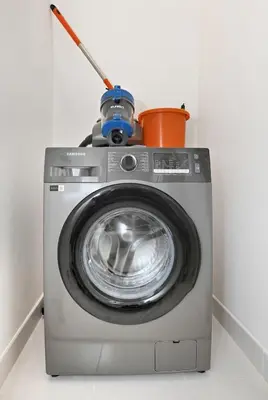 a washing machine with a pot on top of it at Golden Stays - Modern Luxe 4BR Oasis I Peaceful Views in Dubai