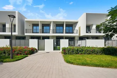 an exterior view of a white building with a driveway at Golden Stays - Modern Luxe 4BR Oasis I Peaceful Views in Dubai