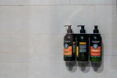 two bottles of soap are hanging on a wall at Chic Urban Studio l Poolside Living l Balcony in Dubai