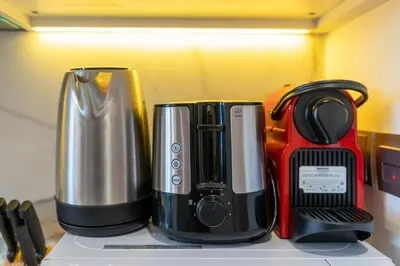 two coffee makers sitting on top of a counter at Chic Urban Studio l Poolside Living l Balcony in Dubai