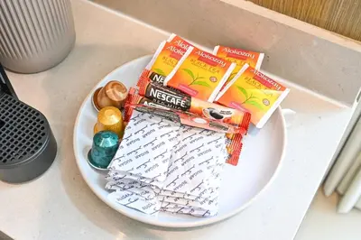 a plate with books and snacks on a table at Golden Stays - Tranquil 4BR Villa I Pool & Coastal Charm in Dubai