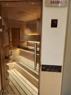 an empty sauna with a clock on the wall at Ramadan Staycay King suite sunset stay sauna beachfront tennis pool and 24h security in Dubai