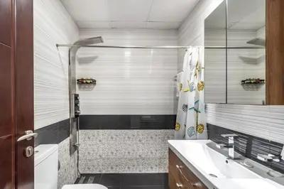 a bathroom with a shower and a toilet and a sink at GuestReady - Studio l Close to Metro Station in Dubai