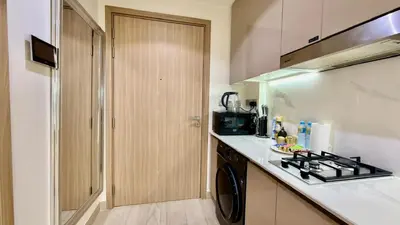 a kitchen with a stove top oven next to a counter at Luxury Stay in Meydan - 10min to Downtown in Dubai