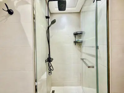 a shower with a glass door in a bathroom at Luxury Stay in Meydan - 10min to Downtown in Dubai