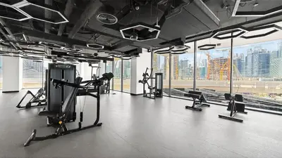 a gym with treadmills and cardio equipment in a building at Golden Stays - Luxe 1BR Retreat I Cinema Access & Elegant Stay in Dubai