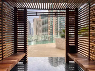 a room with wooden benches and a view of a city at GuestReady - Burj Khalifa View l Rooftop Pool in Dubai