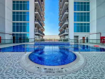 a large swimming pool in the middle of a building at GuestReady - 1BR l Close to Metro Station in Dubai