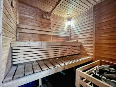 a sauna with a bench in a wooden wall at GuestReady - 1BR l Close to Metro Station in Dubai