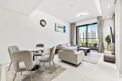 a living room with a table and chairs at BLVD - Stylish Stay with Relaxing Balcony View in Dubai