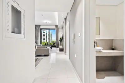a hallway of a house with a bathroom and a living room at BLVD - Stylish Stay with Relaxing Balcony View in Dubai
