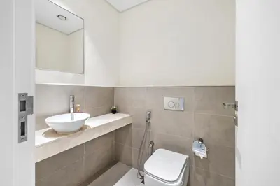a bathroom with a sink and a toilet at BLVD - Stylish Stay with Relaxing Balcony View in Dubai
