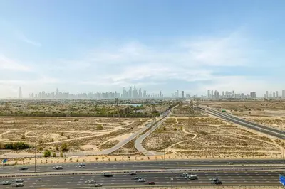 an aerial view of a highway with a city in the background at GuestReady | 2 BR | Luxury Apt with Private Pool in Dubai
