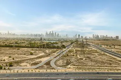 an aerial view of a highway with a city in the background at GuestReady | 2 BR | Luxury Apt with Private Pool in Dubai