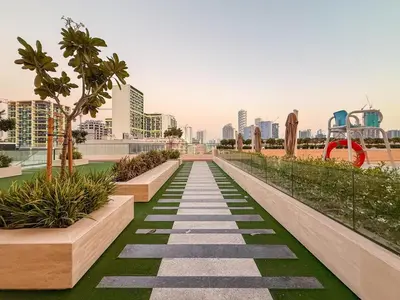 a walkway in the middle of a city at GuestReady | 2 BR | Luxury Apt with Private Pool in Dubai