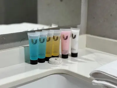 a row of different colored cups sitting on a counter at Modern studio in the centre of Dubai in Dubai