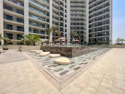 a large apartment building with a fountain in a courtyard at GuestReady - 1BR l Canal View in Business Bay in Dubai