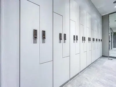 a row of white lockers in a locker room at GuestReady - 1BR l Canal View in Business Bay in Dubai