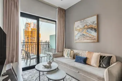 a living room with a couch and a large window at GuestReady - 1BR l Canal View in Business Bay in Dubai