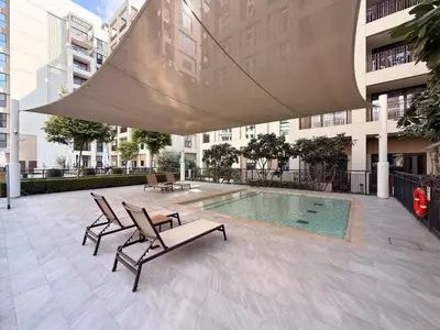 a patio with chairs and a pool in a building at GuestReady - 1BR | Creek Beach Getaway in Dubai
