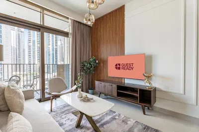 a living room with a couch and a tv at GuestReady - 1BR | Serene Home in Creek Harbour in Dubai