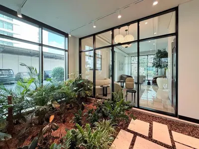 an office building with glass doors and plants at GuestReady - 1BR | Serene Home in Creek Harbour in Dubai