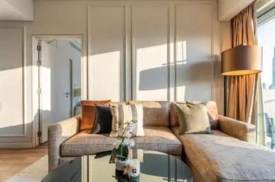 a living room with a couch and a glass table at GuestReady - 1BR | High-Floor Skyline Elegance in Dubai