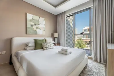 a bedroom with a large white bed and a large window at GuestReady - Private 4BR Villa | Golf Course View in Dubai