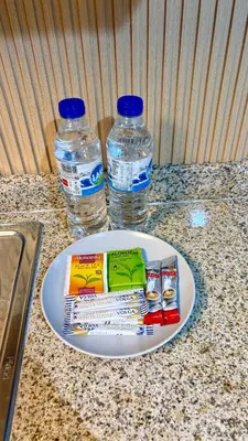 two bottles of water and a plate with toothbrushes and water at Unique 1 bed apart in Business Bay close to downtown in Dubai