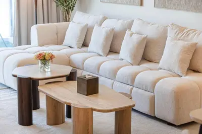 a living room with a couch and two tables at Mahogany 22 - 4BR 16PAX - Burj Khalifa View Central in Dubai